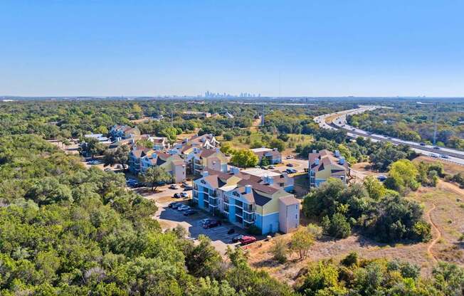 A bird's eye view of a residential area with houses surrounded by greenery.
