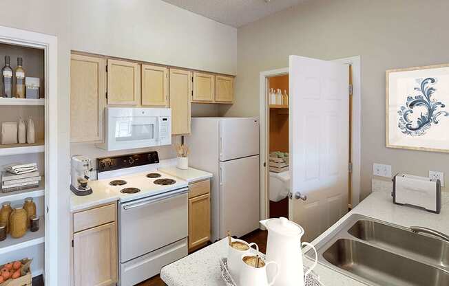 a kitchen with white appliances and wooden cabinets