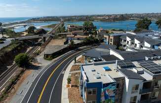 an aerial view of an empty street with houses and a train