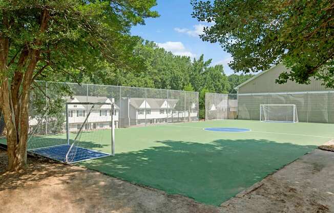 A tennis court surrounded by trees at Dunwoody Glen, Atlanta, GA