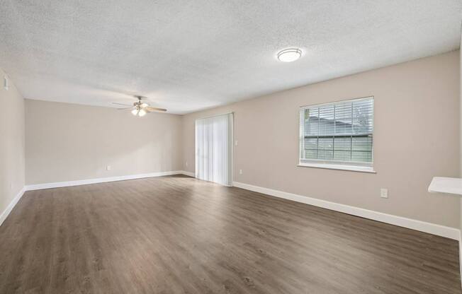Empty room with wooden floor and white ceiling.