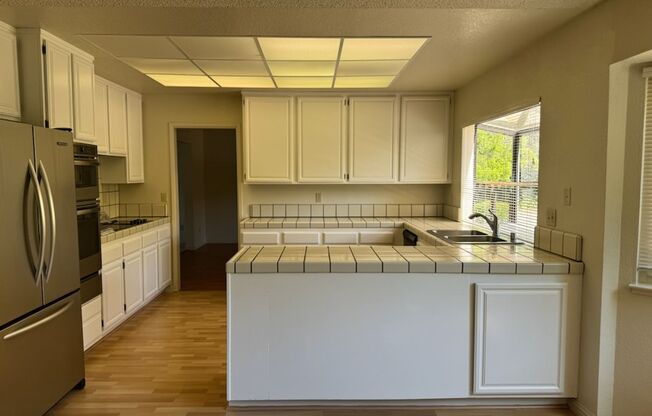 Lots of Square Footage in this wonderful 4 Bedroom (+ Bonus Room) 2.5 Bath Home...Beautiful Park Like Backyard.