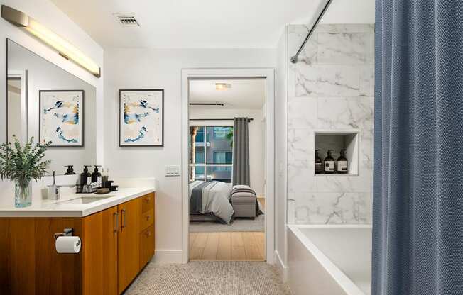 a bathroom with a tub and a sink and a mirror