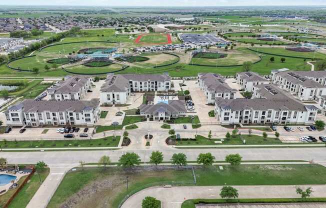 an aerial view of a neighborhood with houses and a parking lot