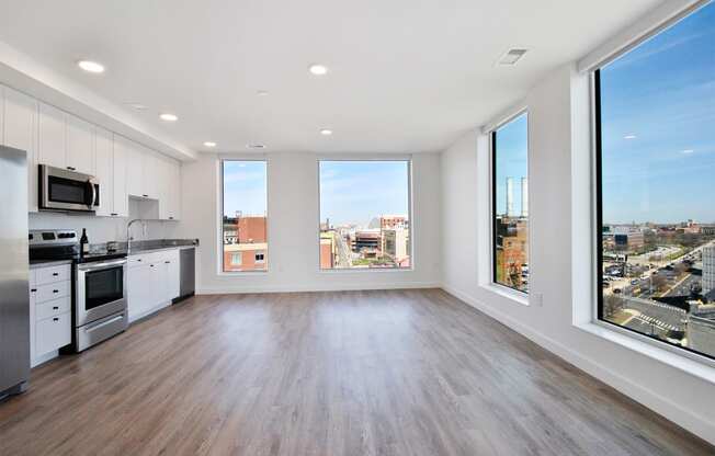 an open kitchen and living room with a view of the city