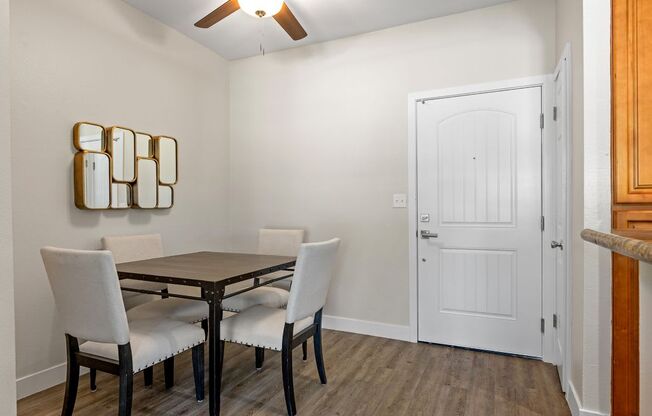 a dining room with a table and chairs