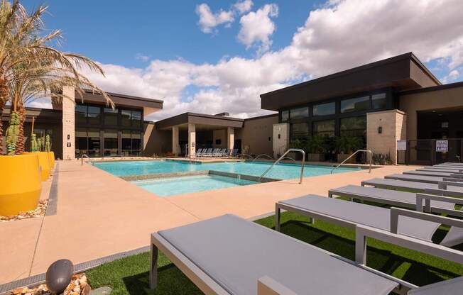 A modern building with a pool in front.