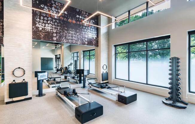 Light-filled fitness studio with reformer machines and strength equipment designed to support every workout.