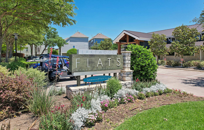 A sign that says Flats in front of a building.