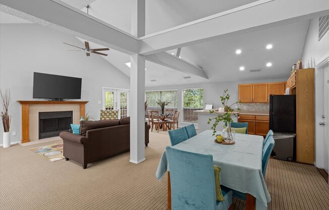 a living room with a table and chairs and a fireplace