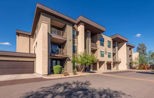 A modern apartment building with a clear blue sky above.