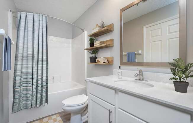 a bathroom with a white sink and a toilet