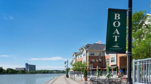 View of outdoor restaurant dining areas along the Genesee River at Corn Hill Landing and apartments above the shops and restaurants
