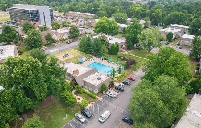 an aerial view of a city with a swimming pool