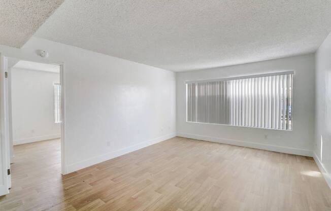 A room with wooden floors and white walls.