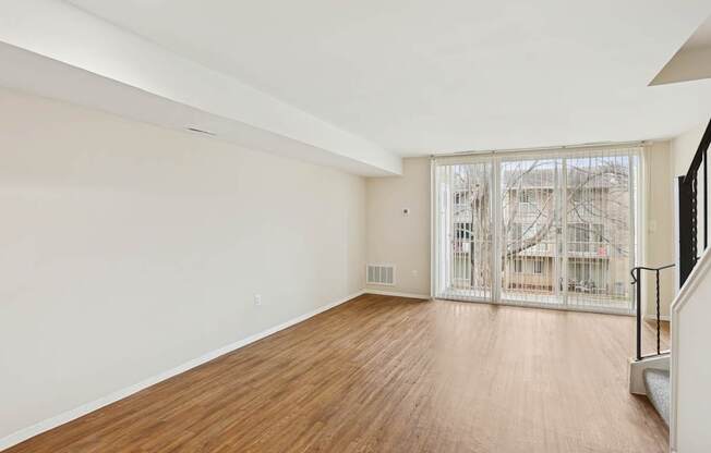Empty room with wooden floor and white walls.