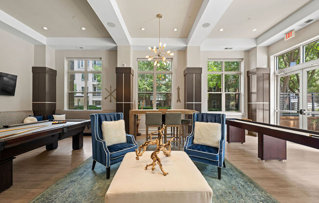 a large living room with tables and chairs and a game room