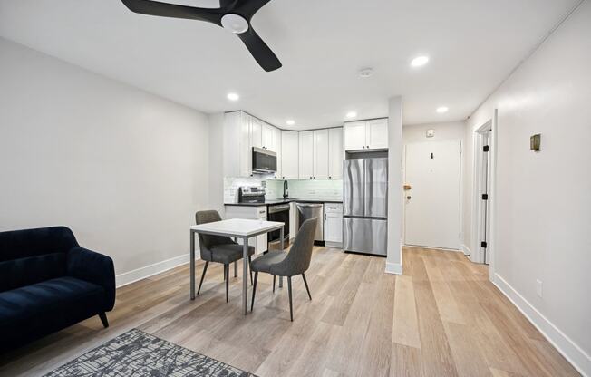 a living room and kitchen with a table and chairs