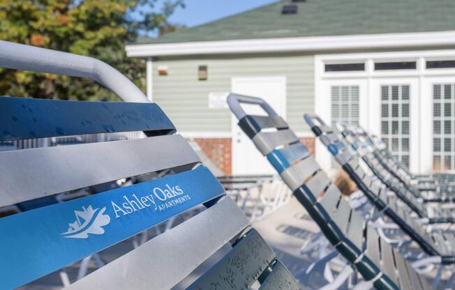 Row of strapped pool lounge chairs at Ashley Oaks Apartments in Greensboro, North Carolina