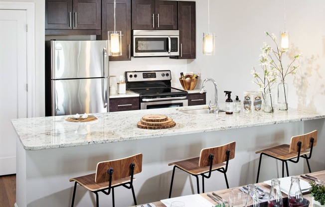 a kitchen with a marble counter top and stainless steel appliances