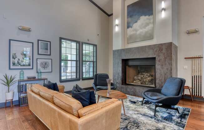 the living room has a large stone fireplace and hardwood flooring