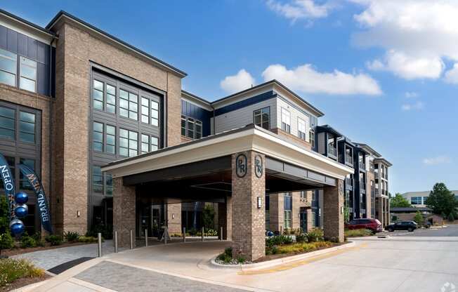 an office building with an entrance and awning on the side of a street at Preston Ridge, Cary, NC, 27513