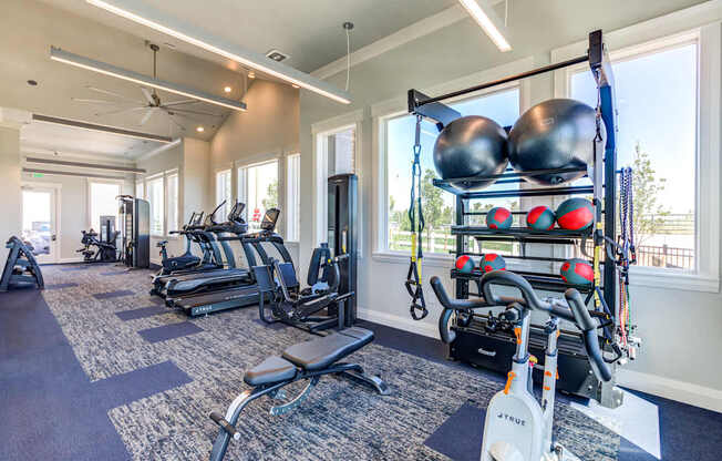 A gym with a variety of equipment including weights and machines.