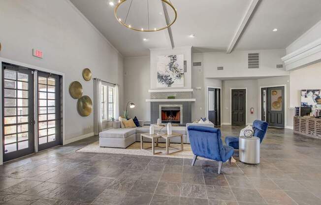 A living room with a fireplace and a blue chair.
