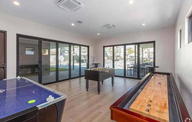 A room with a pool table and air conditioning unit.