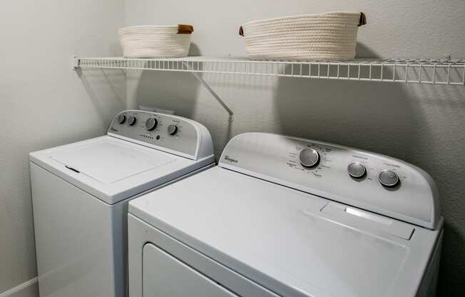 Lyric Apartments washer and dryer sit next to each other in a laundry room