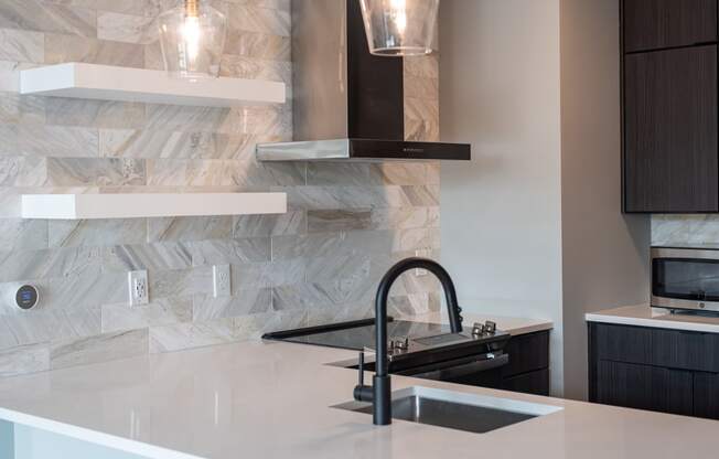 a kitchen counter with a sink and a faucet