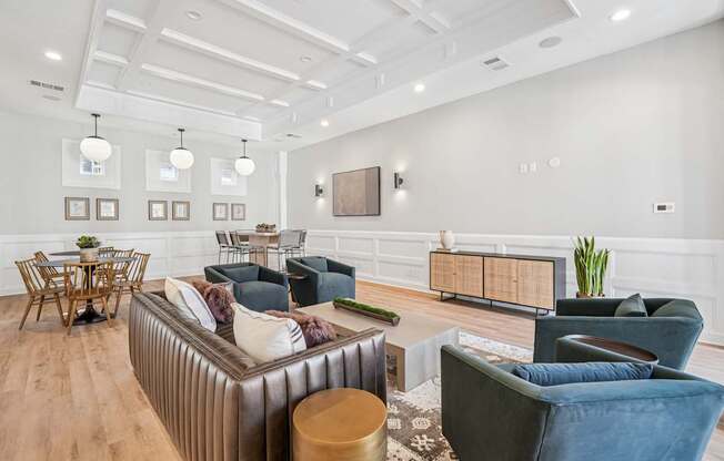 A living room with a brown sofa, a wooden table, and a TV mounted on the wall.