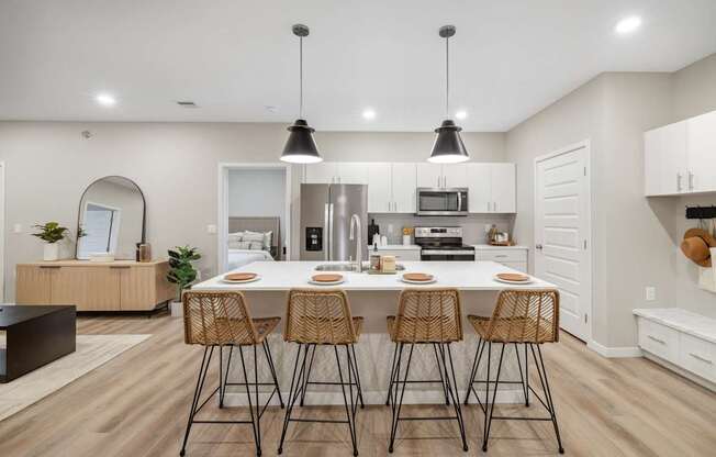 a large dining room with tables and chairs and white walls