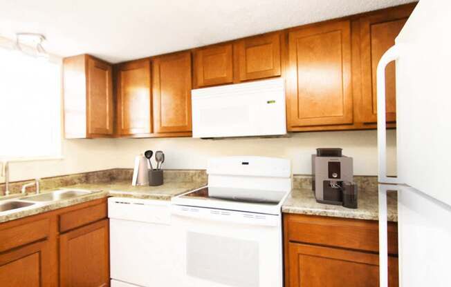 A white oven and microwave are on a counter in a kitchen.