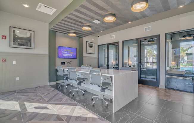 a conference room with a desk and chairs and a tv at Canter, Ocala, FL, 34474