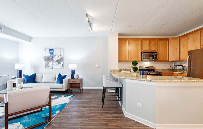 A kitchen with a white counter and wooden cabinets.