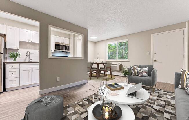 an open living room and kitchen with a table and chairs