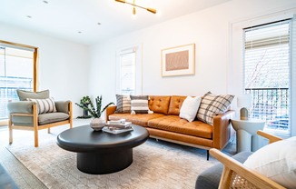 a living room with a leather couch and a coffee table