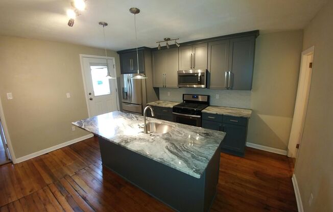 Beautifully renovated gem in South Side. Granite, Stainless, Hardwood Floors, Laundry A/C