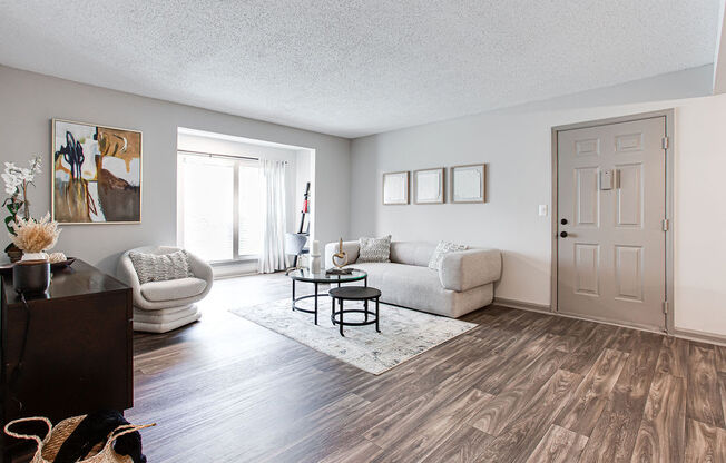 a living room with white couches and a coffee table at Hidden Lake, Union City