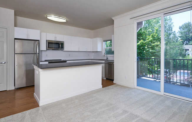 Kitchen with Stainless Steel Appliances and Balcony