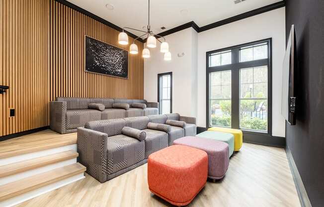 a living room with couches and chairs and a large window