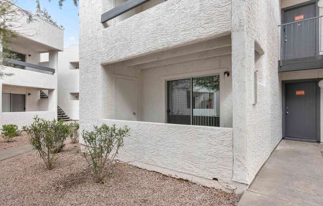 the facade of a white building with a garage door