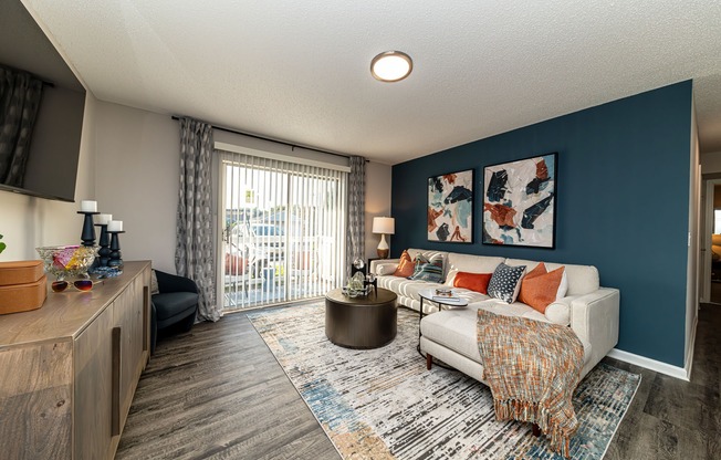 Spacious living room with hardwood-style flooring & overhead lighting