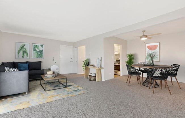 a living room and dining room with a table and chairs