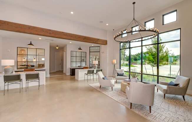 the living room has large windows and a chandelier at Legacy at Cibolo, Boerne, 78006