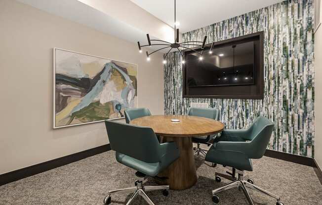 a conference room with a table and chairs and a television