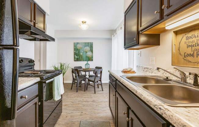 a kitchen with a sink and a stove and a table