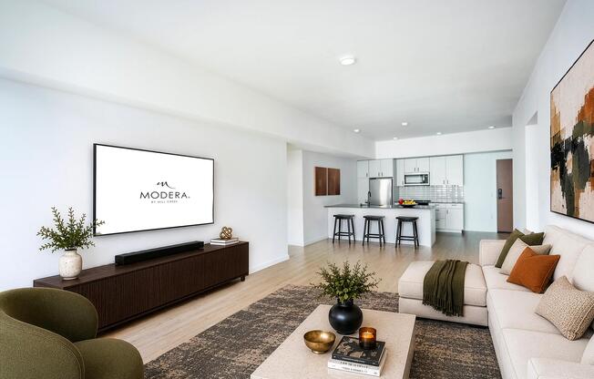 Open living area with clean-lined finishes, a generous lounge space, and a kitchen with bar seating designed for gathering and everyday comfort.