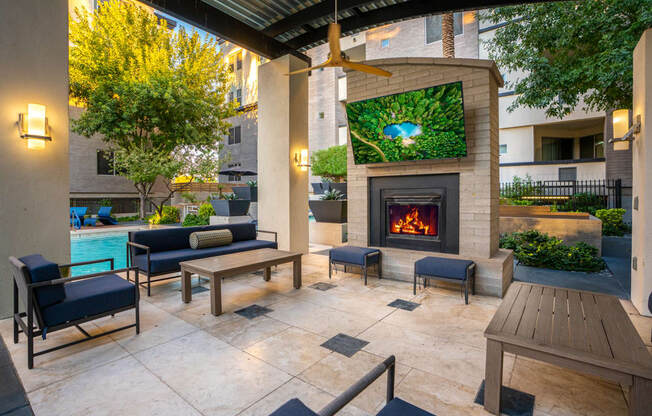 A patio with a fireplace and seating area.